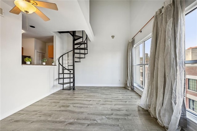 empty room featuring ceiling fan and light wood-type flooring