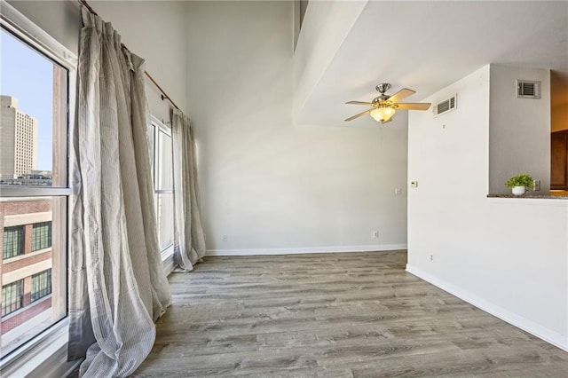 empty room featuring ceiling fan and light hardwood / wood-style flooring