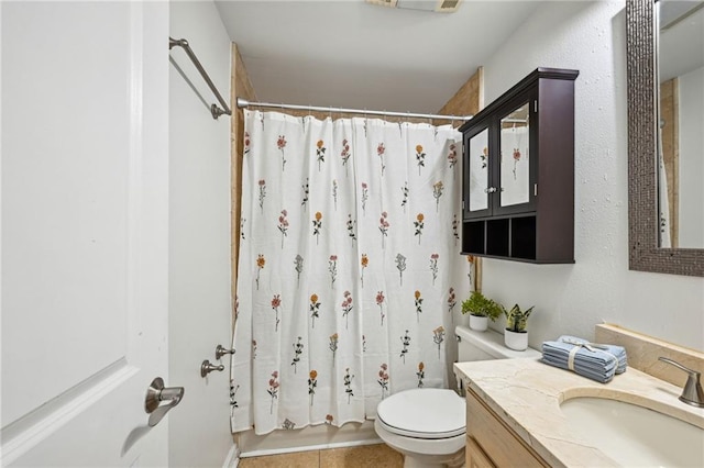 bathroom with vanity, tile patterned floors, and toilet