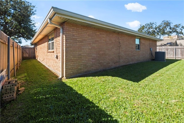 view of property exterior with a lawn and cooling unit