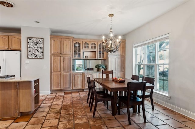 dining space with a chandelier and a healthy amount of sunlight