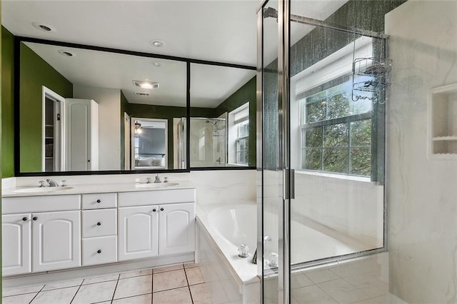 bathroom featuring tile patterned flooring, vanity, and shower with separate bathtub