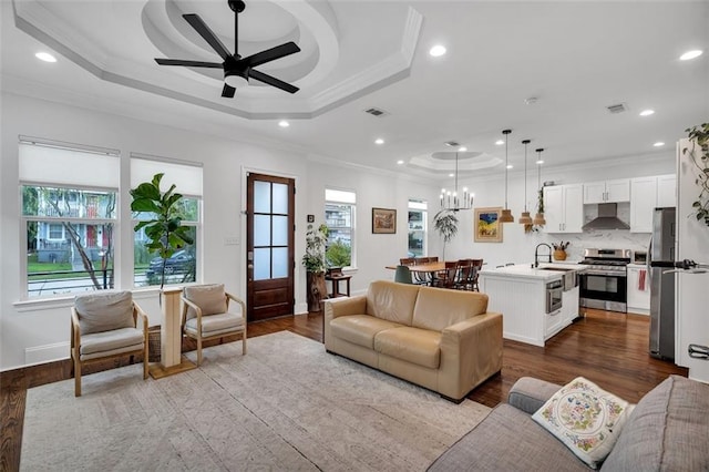 living room with light wood-type flooring, crown molding, and plenty of natural light