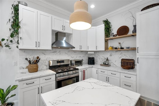 kitchen featuring white cabinetry, wall chimney exhaust hood, and stainless steel gas range oven