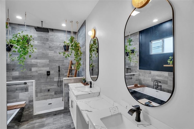 bathroom featuring vanity and separate shower and tub