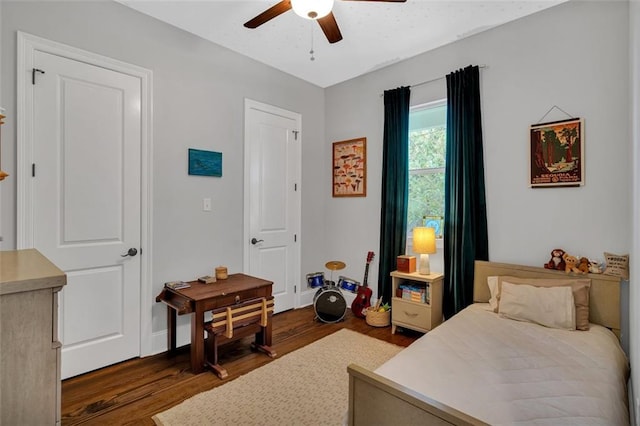 bedroom with ceiling fan and dark hardwood / wood-style floors