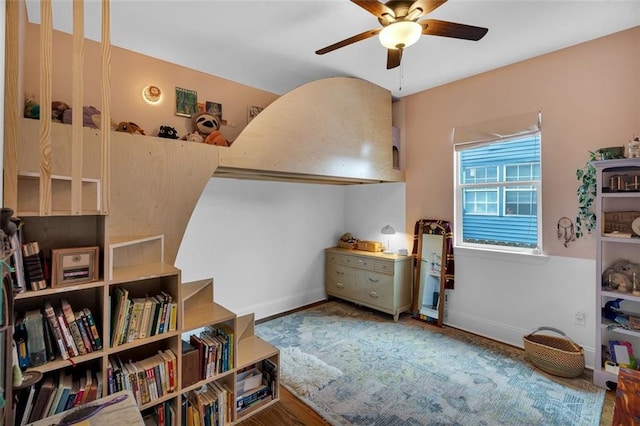 interior space with ceiling fan and wood-type flooring