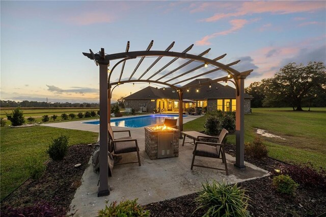 pool at dusk featuring a patio, a yard, and a fire pit