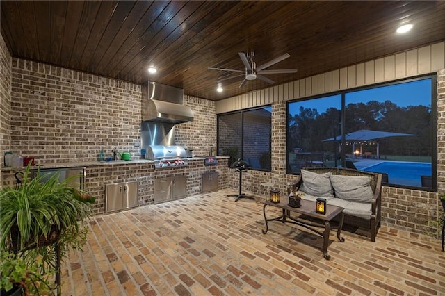 view of patio featuring a grill, ceiling fan, sink, and exterior kitchen