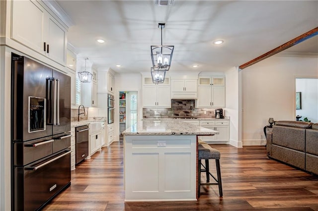 kitchen featuring white cabinets, pendant lighting, dark hardwood / wood-style floors, and appliances with stainless steel finishes