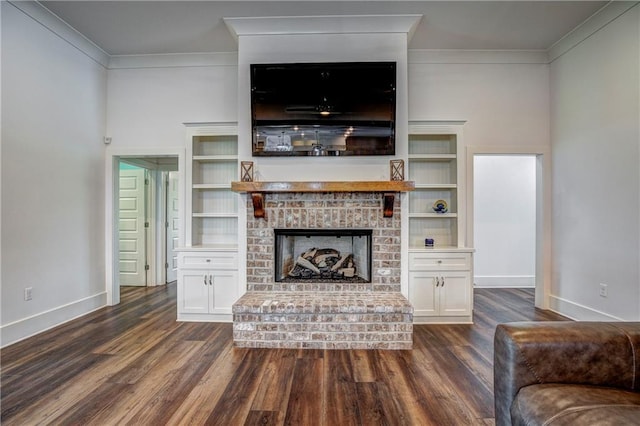 unfurnished living room with dark hardwood / wood-style floors, crown molding, and a fireplace