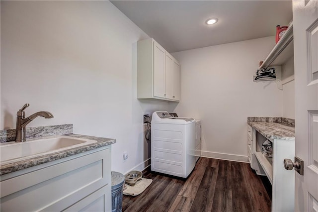 laundry room featuring cabinets, dark hardwood / wood-style flooring, washing machine and clothes dryer, and sink