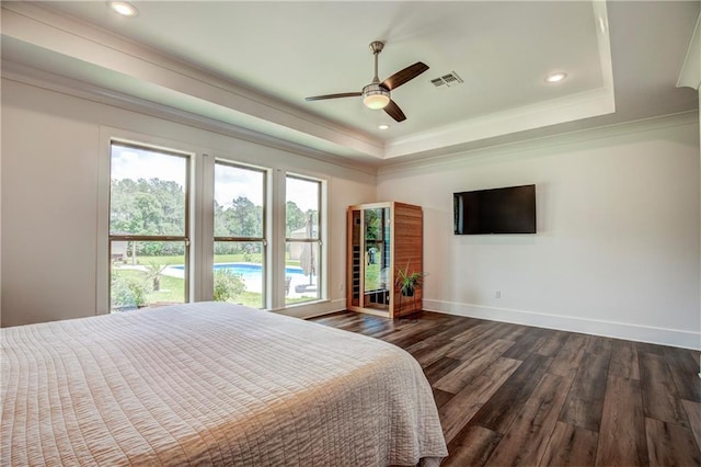 bedroom with dark hardwood / wood-style floors, a raised ceiling, ceiling fan, and crown molding