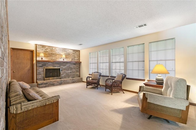 carpeted living room featuring a fireplace and a textured ceiling