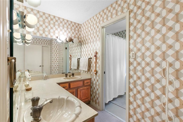 bathroom with vanity and a textured ceiling