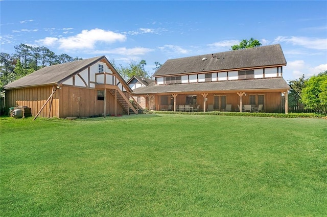 rear view of house featuring a yard