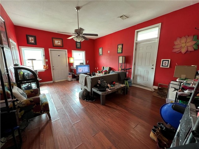 living room featuring ceiling fan and wood-type flooring