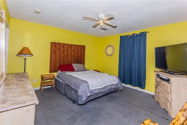 bedroom featuring dark colored carpet and ceiling fan