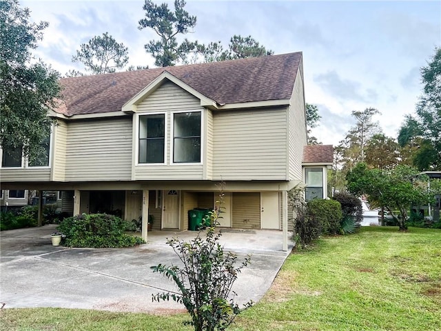 view of front facade with a carport and a front lawn