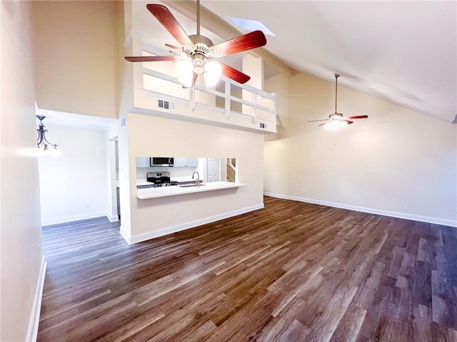 unfurnished living room featuring high vaulted ceiling, dark hardwood / wood-style flooring, ceiling fan, and sink