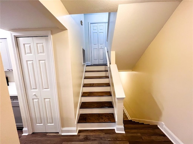 staircase with hardwood / wood-style floors