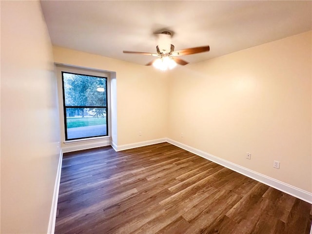 empty room featuring ceiling fan and dark hardwood / wood-style flooring