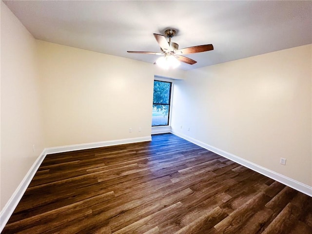 spare room with ceiling fan and dark hardwood / wood-style flooring