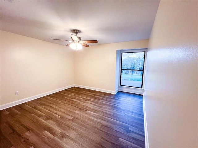 unfurnished room with dark wood-type flooring and ceiling fan