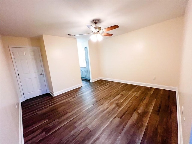 spare room featuring ceiling fan and dark hardwood / wood-style floors