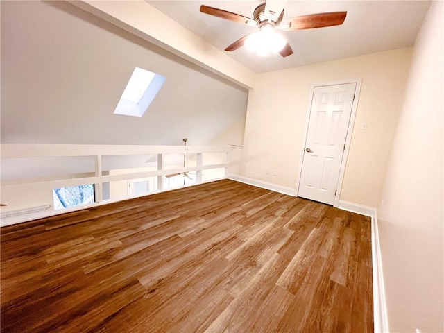 clothes washing area with a skylight, hardwood / wood-style flooring, and ceiling fan