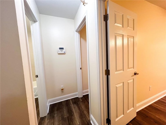 hallway with dark hardwood / wood-style flooring