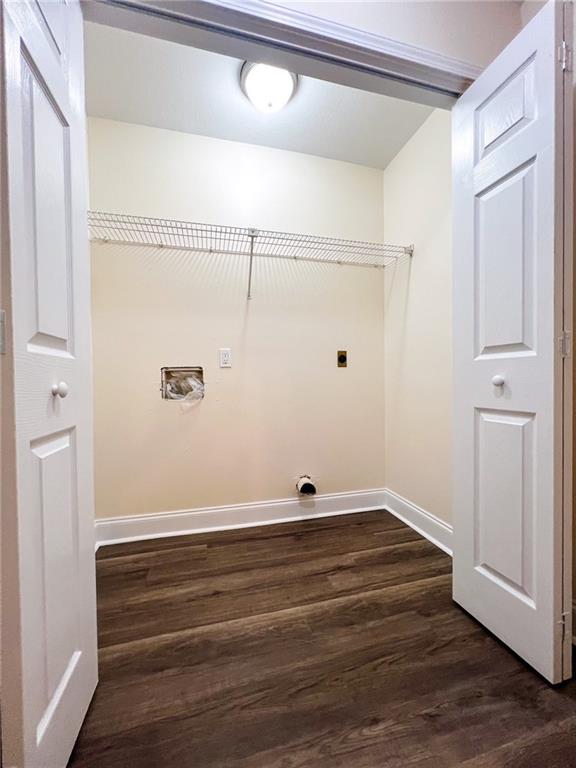 laundry area featuring dark hardwood / wood-style floors and hookup for an electric dryer