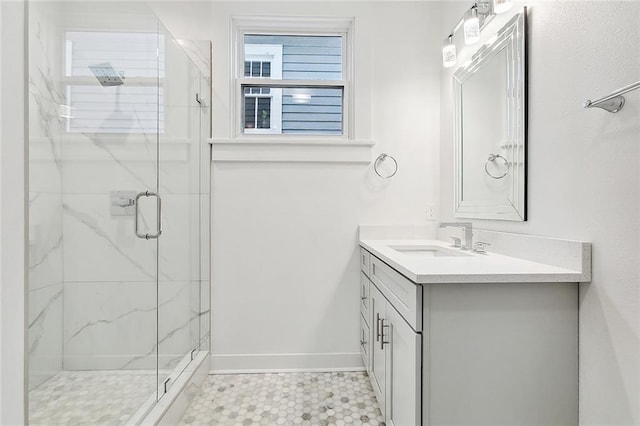 bathroom with a shower with door and vanity