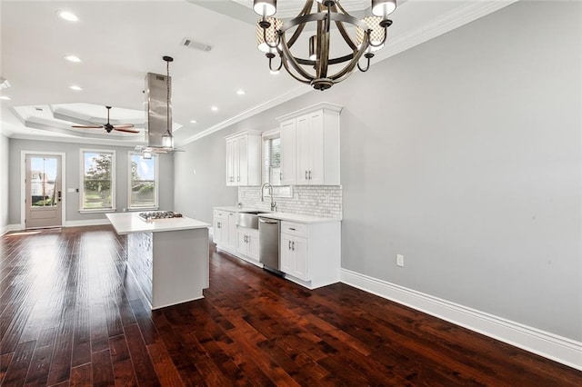 kitchen with dark wood-type flooring, white cabinetry, appliances with stainless steel finishes, and a kitchen island