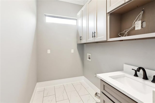 clothes washing area featuring cabinets, washer hookup, and sink