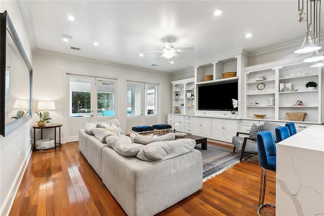 living room featuring ceiling fan, french doors, dark hardwood / wood-style floors, and crown molding