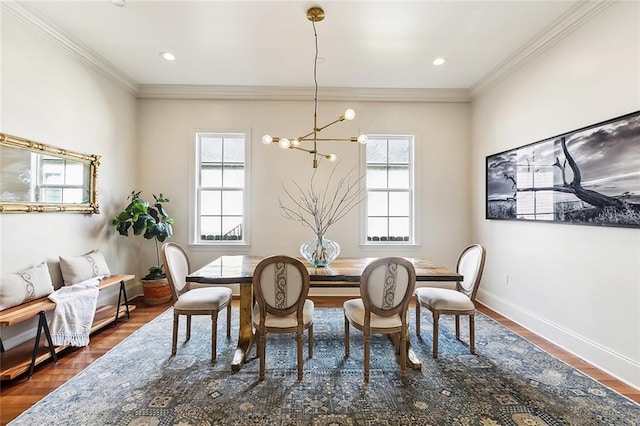 dining area with dark hardwood / wood-style floors, a notable chandelier, and ornamental molding