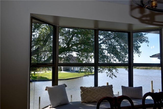 sunroom / solarium with a water view