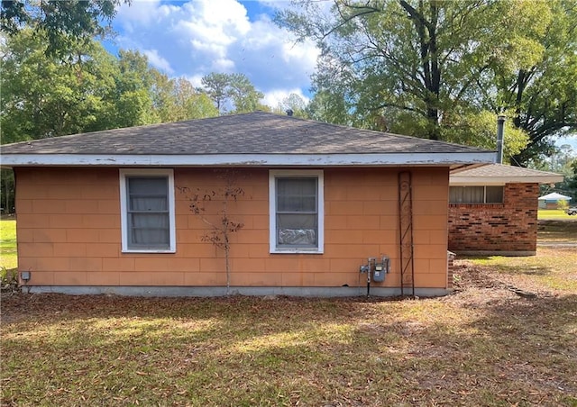 view of home's exterior with a yard