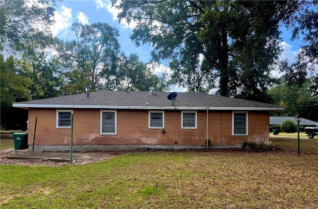 rear view of property with a yard