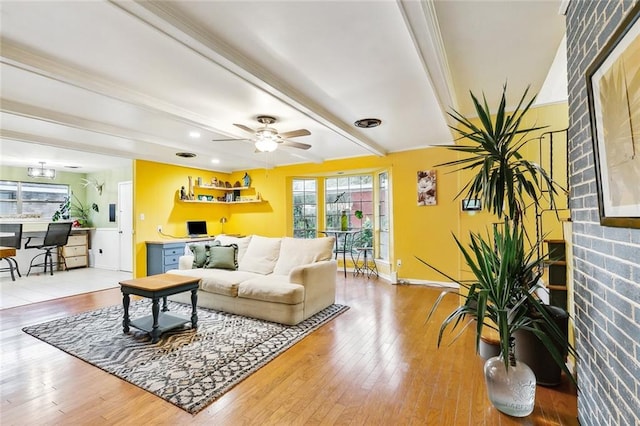 living room featuring hardwood / wood-style floors, ceiling fan, and beam ceiling