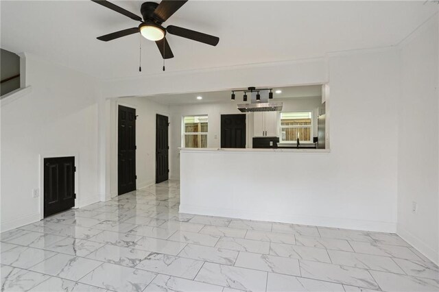 unfurnished living room with ceiling fan