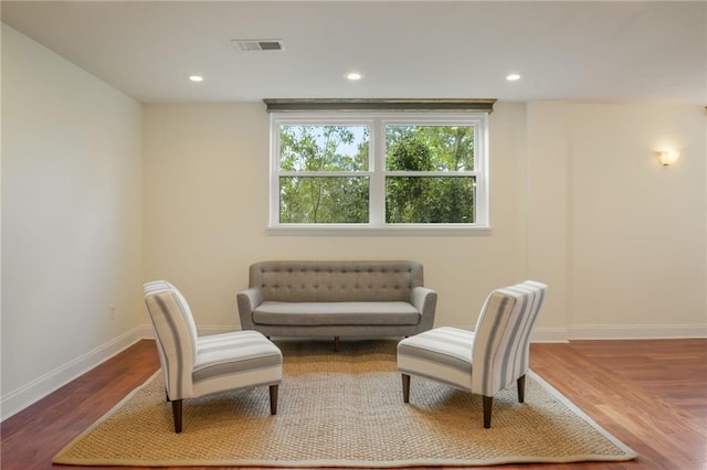 sitting room with wood-type flooring