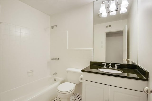 full bathroom featuring vanity, tile patterned floors, tiled shower / bath, and toilet