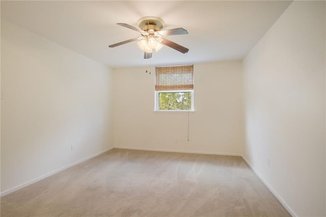 spare room with light carpet and ceiling fan