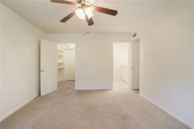 empty room with ceiling fan and light colored carpet