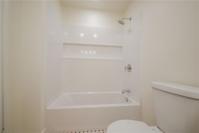 bathroom featuring shower / bathing tub combination and toilet