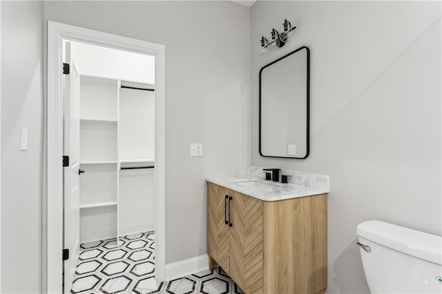 bathroom featuring toilet and vanity