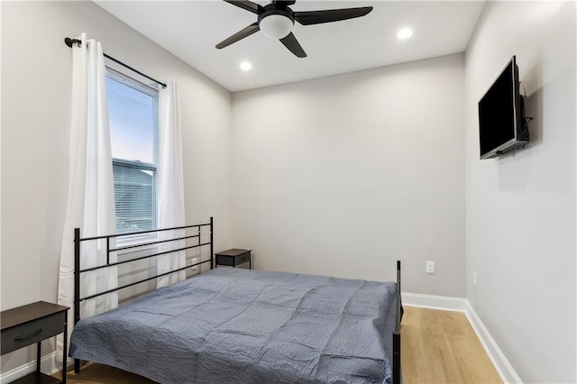 bedroom featuring light wood-type flooring and ceiling fan