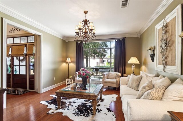 living room with a healthy amount of sunlight, dark hardwood / wood-style floors, and ornamental molding